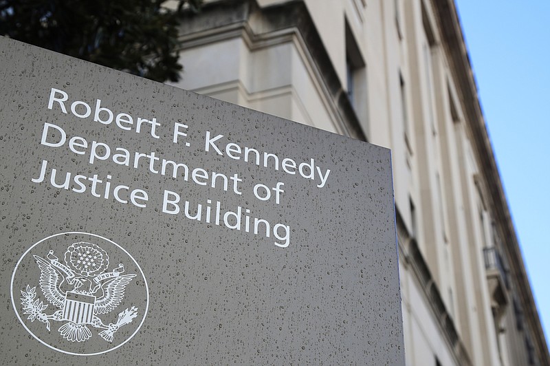 FILE - This Friday, March 22, 2019, file photo shows the Department of Justice Building in Washington. The U.S. Department of Justice is opening a sweeping antitrust investigation of major technology companies and whether their online platforms have hurt competition, suppressed innovation or otherwise harmed consumers. (AP Photo/Manuel Balce Ceneta, File)