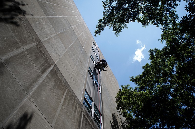 Firefighter William Crackel, right, helps "rescue" Capt. David Tallent at the Chattanooga State Office Building on the campus of the University of Tennessee at Chattanooga on Wednesday, July 24, 2019 in Chattanooga, Tenn. Firefighters were participating in a rope-rescue training scenario on the third day of a two-week long class.