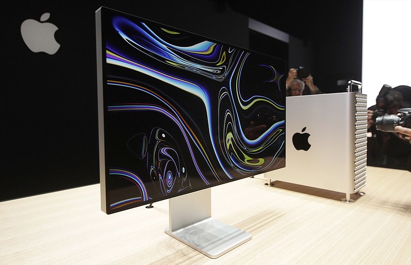 In this June 3, 2019, file photo a monitor of the Mac Pro is shown in the display room at the Apple Worldwide Developers Conference in San Jose, Calif. President Donald Trump is vowing to slap tariffs on Apple's Mac Pros if the company shifts production of the computer from Texas to China. The pledge made in a Friday, Jul 26, tweet rebuffs Apple's attempt to shield its products from taxes being imposed on goods made in China as part of Trump administration's trade war with the world's most populous country. (AP Photo/Jeff Chiu, File)