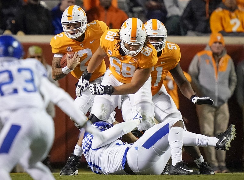 Tennessee offensive linemen Marcus Tatum (68) and Drew Richmond, right, block for quarterback Jarrett Guarantano (left) during last season's home game against Kentucky.