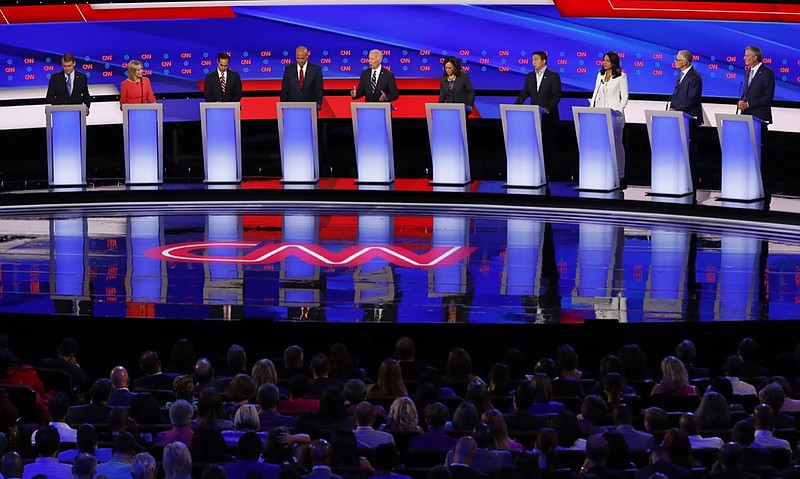 From left, Sen. Michael Bennet, D-Colo., Sen. Kirsten Gillibrand, D-N.Y., former Housing and Urban Development Secretary Julian Castro, Sen. Cory Booker, D-N.J., former Vice President Joe Biden, Sen. Kamala Harris, D-Calif., Andrew Yang, Rep. Tulsi Gabbard, D-Hawaii, Washington Gov. Jay Inslee and New York City Mayor Bill de Blasio participate in the second of two Democratic presidential primary debates hosted by CNN Wednesday, July 31, 2019, in the Fox Theatre in Detroit. (AP Photo/Paul Sancya)