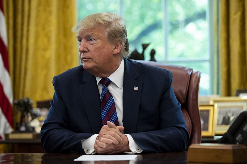 President Donald Trump sits in the Oval Office recently. About half of registered voters believe Trump is racist, according to a new national poll released in July. The poll shows voters are sharply divided along partisan lines on the question. (Anna Moneymaker/The New York Times)