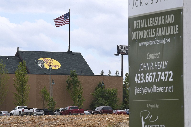 A sign promoting development stands on land near the Bass Pro Shop in East Ridge. / Staff file photo by Robin Rudd
