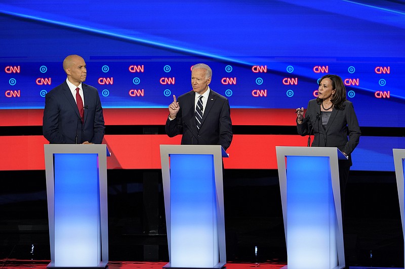 Former Vice President Joe Biden, center, and Sen. Kamala Harris, D-California, speak Wednesday during the second night of Democratic presidential debates in Detroit. At left is Sen. Cory Booker, D-New Jersey. (Erin Schaff/The New York Times)