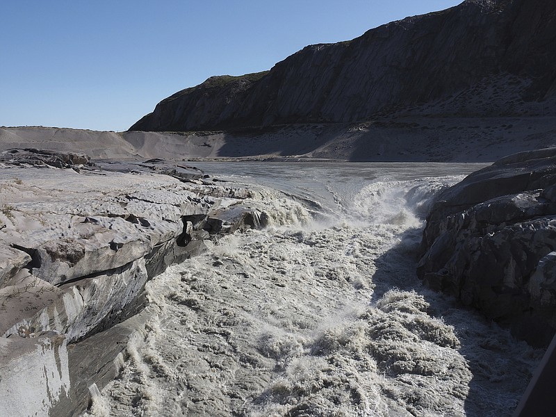 In this image taken on Thursday Aug.1, 2019, melt water flows into the fjord near Kangerlussaq in western Greenland. The heat wave that smashed high temperature records in five European countries a week ago is now over Greenland, accelerating the melting of the island's ice sheet and causing massive ice loss in the Arctic. (Photo via Caspar Haarløv, Into the Ice via AP)