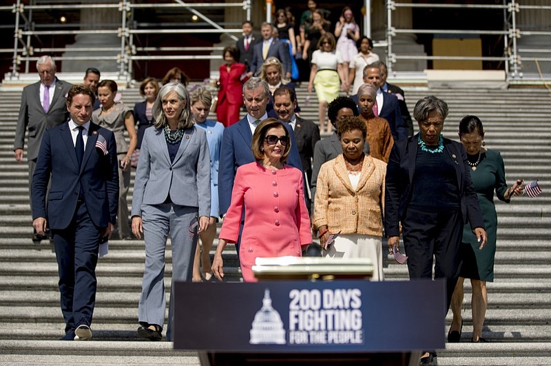 In this July 25, 2019, photo, House Speaker Nancy Pelosi of Calif., and House Democrats arrive for a news conference on the first 200 days of the 116th Congress at the House East Front steps of the Capitol in Washington. Nearly half the House Democrats now support an impeachment inquiry of President Donald Trump in the aftermath of Robert Mueller's testimony to Congress. (AP Photo/Andrew Harnik)