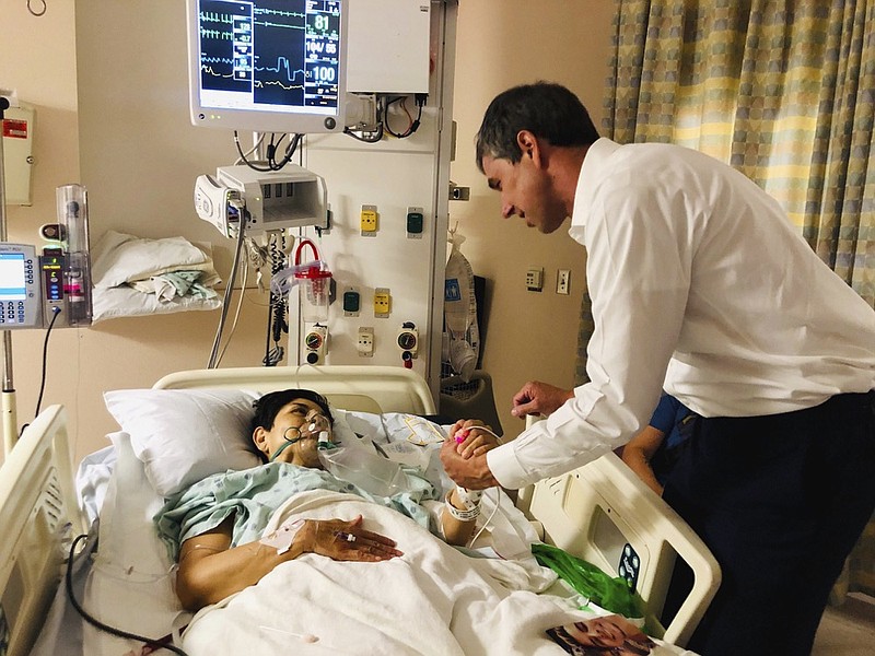 In this image provided by Beto O'Rourke's Facebook page, Presidential candidate and former congressman Beto O'Rourke, right, meets with mass shooting survivor, Rosemary, at University Medical Center in El Paso, Texas on Sunday, Aug. 4, 2019. A gunman opened fire in an El Paso shopping area during the busy back-to-school season Saturday, killing at least a dozen. (Beto O'Rourke Facebook via AP)