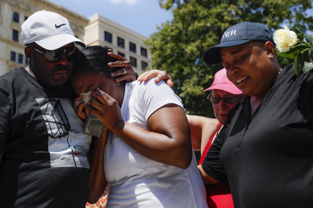 Mourners gather at a vigil following a nearby mass shooting, Sunday, Aug. 4, 2019, in Dayton, Ohio. Multiple people in Ohio have been killed in the second mass shooting in the U.S. in less than 24 hours, and the suspected shooter is also deceased, police said. (AP Photo/John Minchillo)