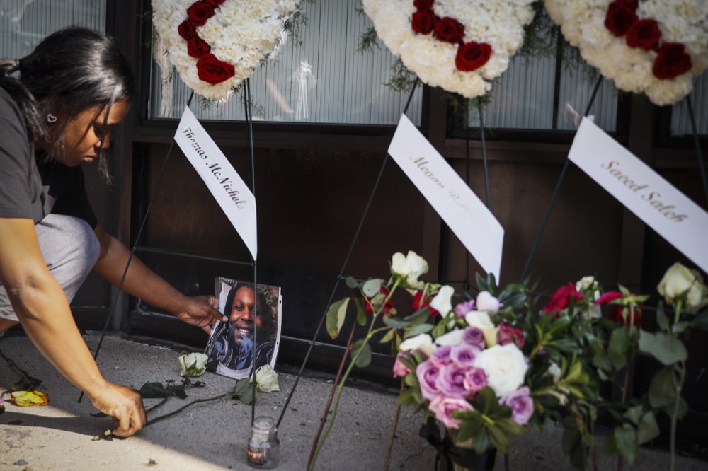 Jamila McNichols, sister of slain mass shooting victim Thomas “TJ” McNichols, mourns beside a memorial near the scene of the crime, Monday, Aug. 5, 2019, in Dayton, Ohio. (AP Photo/John Minchillo)