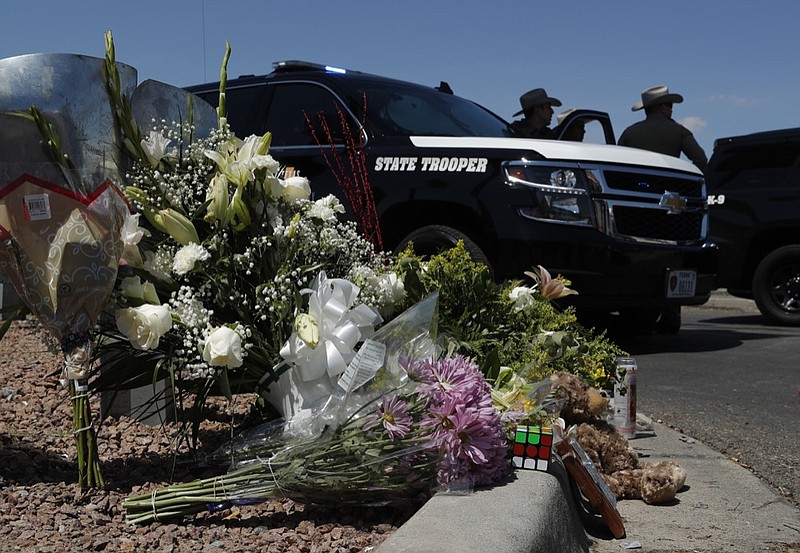 Flowers adorn a makeshift memorial near the scene of a mass shooting at a shopping complex in El Paso. (AP Photo/John Locher)