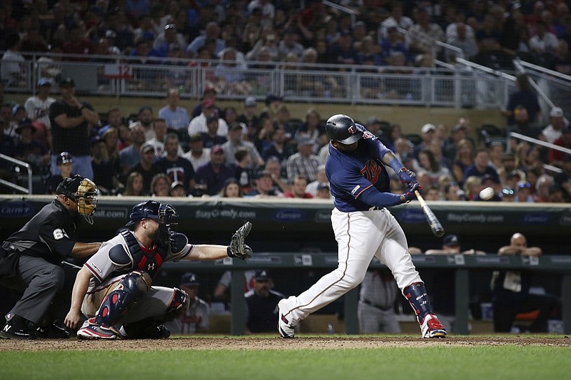 Minnesota Twins' Miguel Sano, right, hits a home run to win a baseball game against the Atlanta Braves during the ninth inning Monday, Aug. 5, 2019, in Minneapolis. (AP Photo/Stacy Bengs)