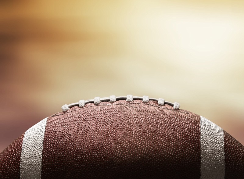 American football ball on black background football tile / Getty Images
