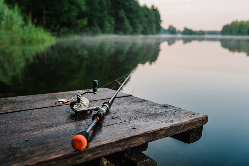 Fishing rod, spinning reel on the background pier river bank. Sunrise. Fog against the backdrop of lake. Misty morning. wild nature. The concept of rural getaway. Article about fishing day. fishing tile / Getty Images
