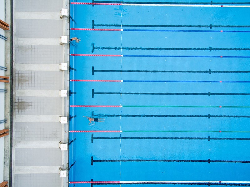 Captured top view of swimming pool and 2 swimmer swim tile swim sport / Getty Images
