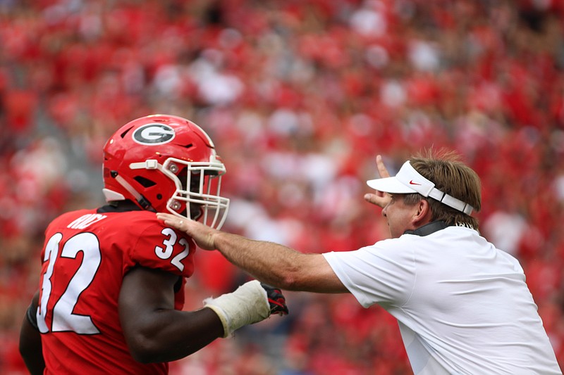 Georgia inside linebacker Monty Rice listens to instructions from Bulldogs coach Kirby Smart during a game last season in Sanford Stadium. / Georgia photo/Lauren Tolbert