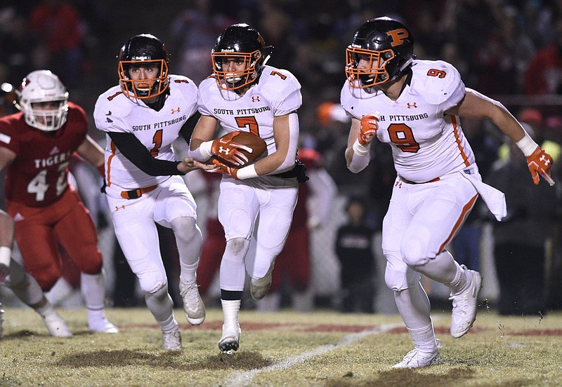 Pirate quarterback Brayden Sanders (1) hands off to Ronto Tipton (7) while Garrett Raulston (9) runs interference.  The Whitwell Tigers hosted the South Pittsburg Pirates in the quarterfinal game of the Class 1A football playoffs on November 16, 2018. 