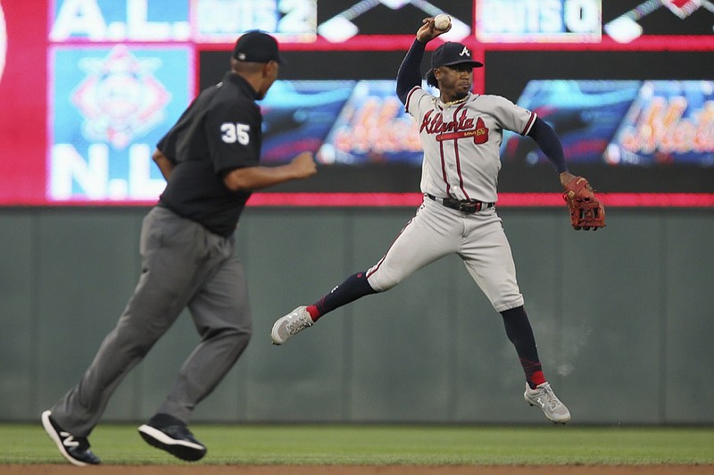 Atlanta Braves' Ozzie Albies, right, throws to first base after grabbing a ball hit by Minnesota Twins' Nelson Cruz during the fourth inning of a baseball game Monday, Aug. 5, 2019, in Minneapolis. (AP Photo/Stacy Bengs)


