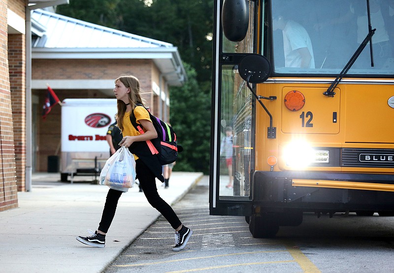 Lilly Howell, an eighth grader at Signal Mountain Middle/High School, gets off the bus for the first day of school Wednesday, August 7, 2019 in Signal Mountain, Tennessee. Both Signal Mountain Middle/High School and Nolan Elementary had different start times from past years.