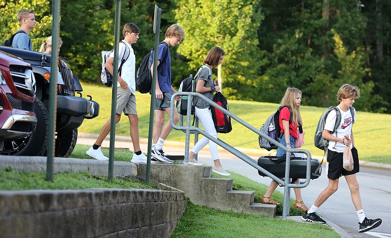 A group of Signal Mountain Middle/High School students walk from the parking lot to the front entrance of the school Wednesday, August 7, 2019 in Signal Mountain, Tennessee. Wednesday was the first day of the 2019-2020 school year for Hamilton County Schools. 