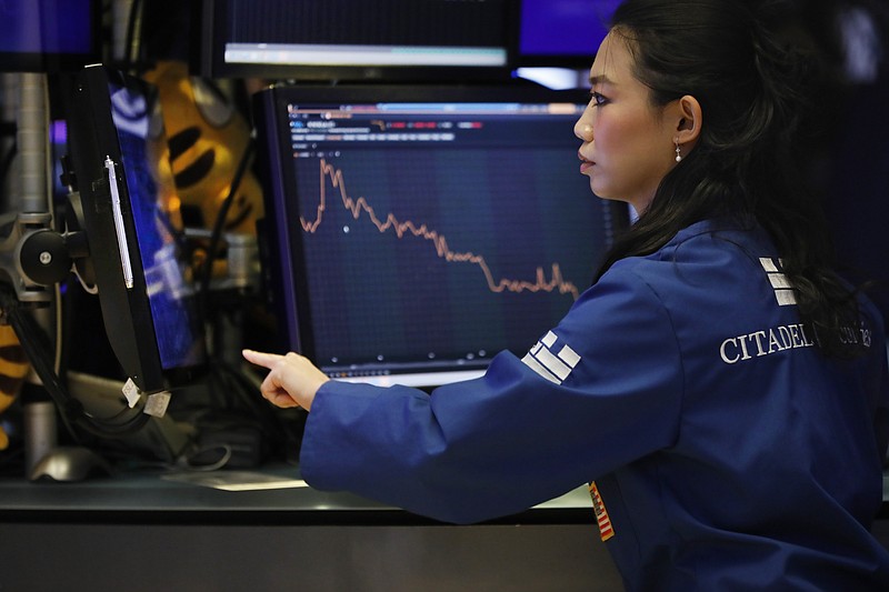Specialist Lingbo Jiang works on the floor of the New York Stock Exchange, Wednesday, Aug. 7, 2019. U.S. stocks fell broadly in midday trading Wednesday as central banks around the world cut interest rates and increased fears that global growth is being crimped by the U.S.-China trade war. (AP Photo/Richard Drew)