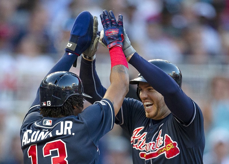 Atlanta Braves' Freddie Freeman, right, is congratulated by Atlanta Braves Ronald Acuna Jr. (13) after hitting a three-run home run in against the Minnesota Twins in the third inning during a baseball game Tuesday, Aug. 6, 2019 in Minneapolis. (AP Photo/Andy Clayton- King)