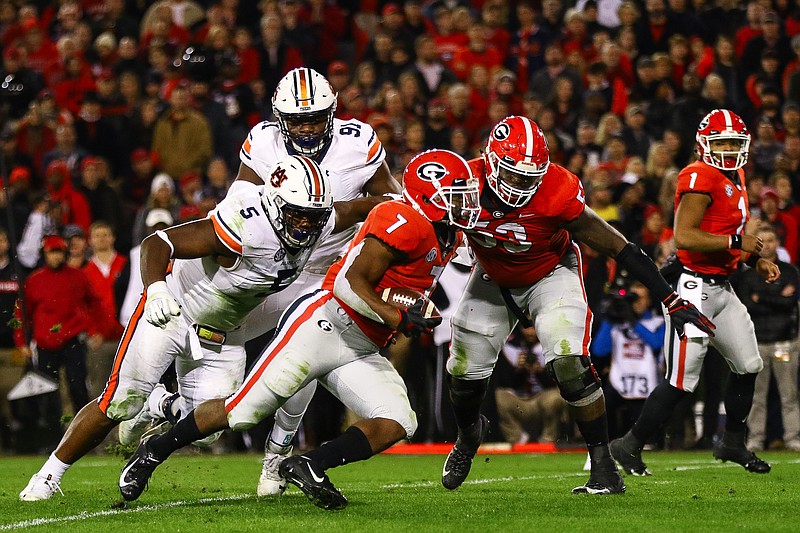 Georgia and running back D'Andre Swift (7) got the better of Auburn and defensive lineman Derrick Brown (5) during last November's game in Athens. When the teams meet in Sanford Stadium again in 2020, the game will be in October. / Georgia photo/Kristin Bradshaw