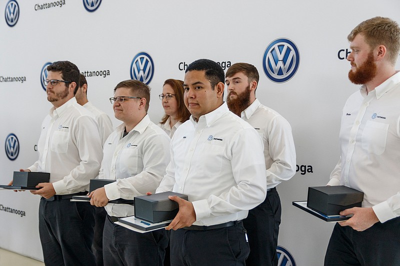 Staff photo by Doug Strickland/ Graduates stand with their certificates during a graduation during ceremony at Volkswagen Academy on Thursday, Aug. 8, 2019, in Chattanooga, Tenn. This graduating class consisted of seven graduates.