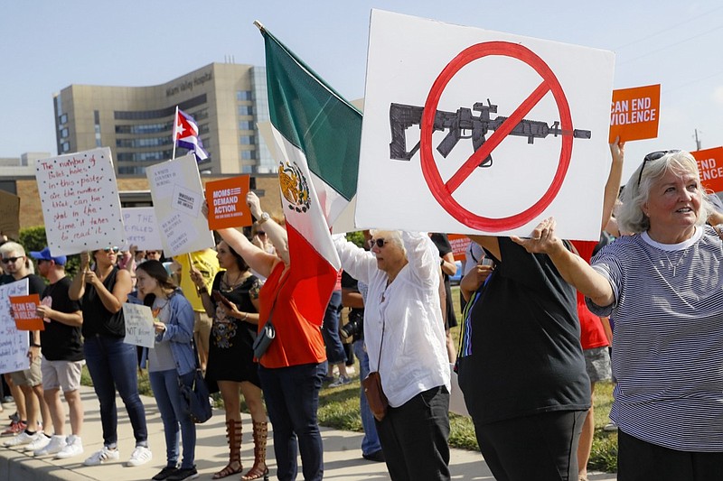 In this Aug. 7, 2019, file photo, demonstrators gather to protest after a mass shooting that occurred in Dayton, Ohio. The latest mass shootings in the United States have triggered multiple countries to warn their citizens to be wary of travel conditions there. (AP Photo/John Minchillo, File)