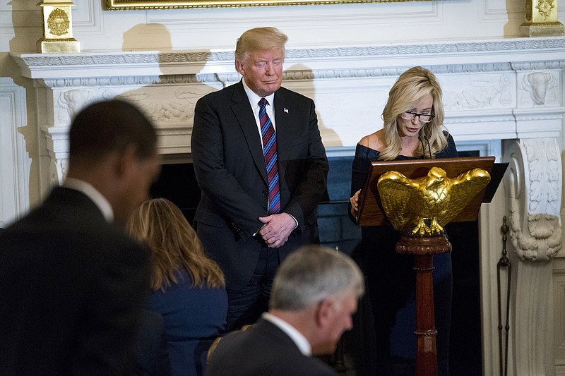 President Donald Trump closes his eyes during a prayer lead by pastor Paula White during a dinner celebrating evangelical leadership in the State Dining Room at the White House in Washington, Aug. 27, 2018. (Doug Mills/The New York Times)