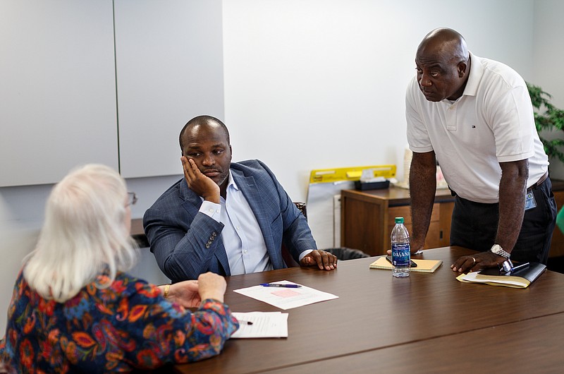 Hamilton County Schools Superintendent Bryan Johnson talks with new COO Kenneth Bradshaw, right, and Christie Jordan after a meeting at the central office building on Thursday, July 12, 2018, in Chattanooga, Tenn. Johnson is wrapping up his first year as superintendent.