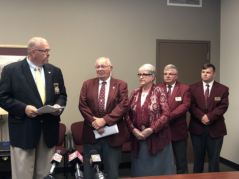 Catoosa County Sheriff Gary Sisk looks on as members of the Wilson Funeral Home talk about the insurance scandal that has affected their business. From left to right - Leroy, Glenda, David and Spencer Wilson attended the press conference Friday afternoon in Ringgold.