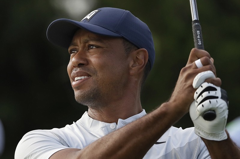 Tiger Woods tees off on the 12th hole at the Northern Trust golf tournament at Liberty National Golf Course, Thursday, Aug. 8, 2019, in Jersey City, N.J. (AP Photo/Mark Lennihan)