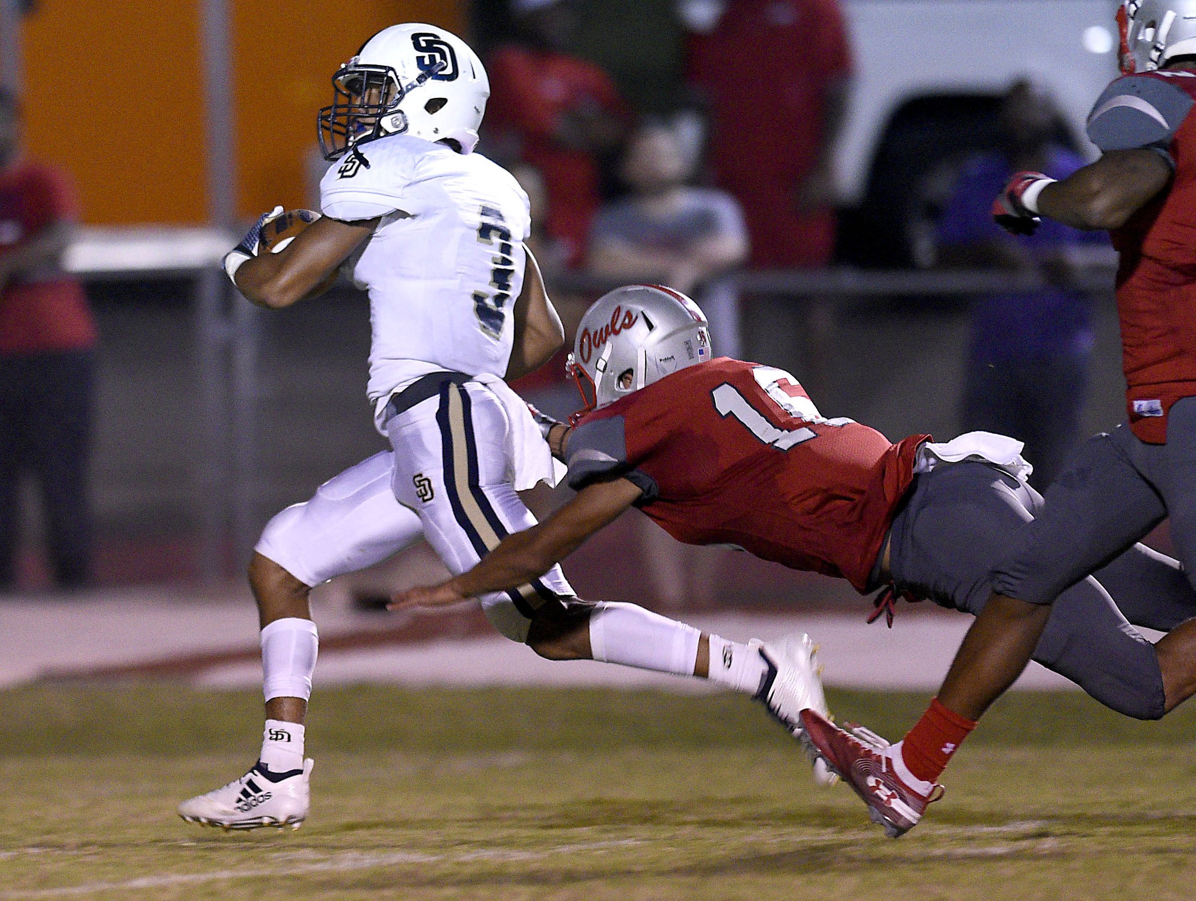 KeSean Eubanks (3) outruns two Owls for a touchdown. The Soddy-Daisy Trojans visited the Ooltewah Owls in a TSSAA rivalry game on September 21, 2018.