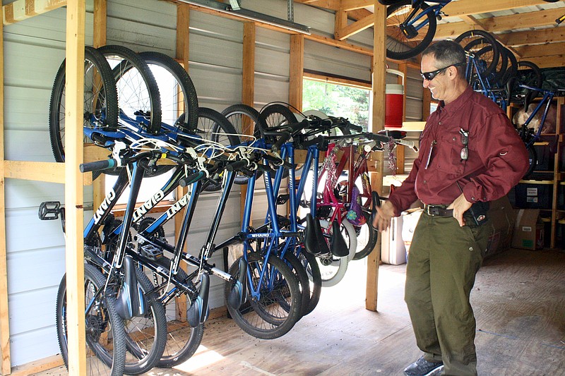 David Hoover, an adventure education facilitator at Parkridge Valley's Child and Adolescent campus, talks about how cycling and other recreational activities can help behavioral health patients at the campus bike shop on Wednesday, Aug. 7, 2019. / Staff photo by Elizabeth Fite