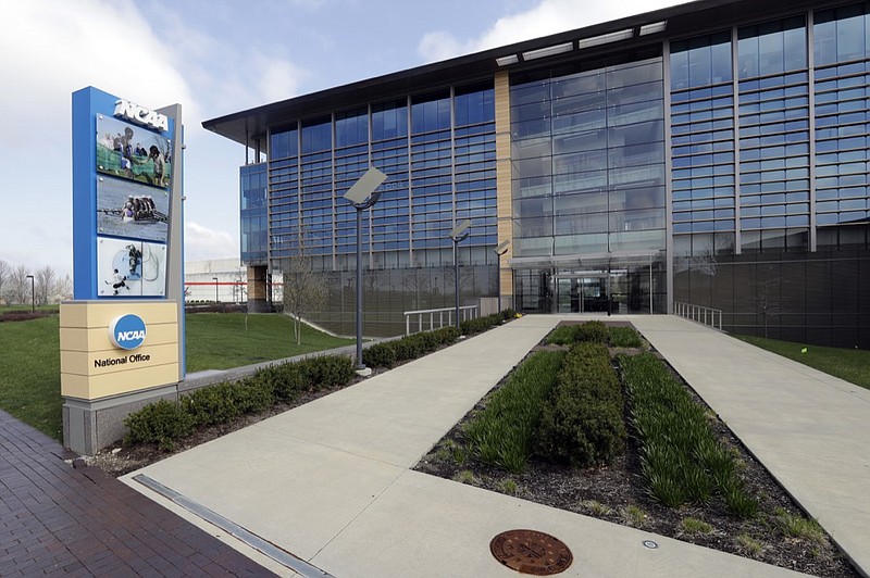 In this April 25, 2018, file photo, NCAA headquarters in Indianapolis is viewed. The NCAA has backtracked on its new agent certification standards and will no longer require a bachelor's degree for those who will be p