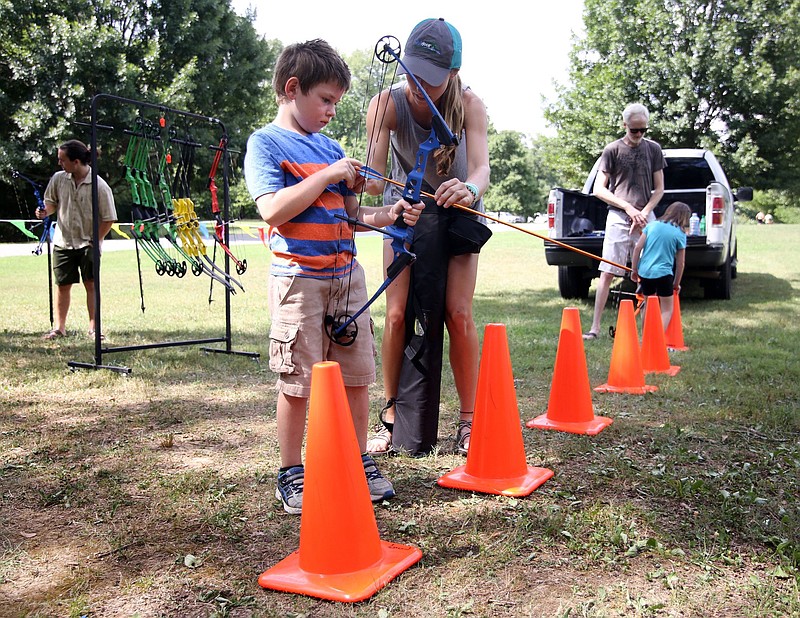 Brian Szakacs, 6, gets help from Madison Bowers, a recreation specialist with Outdoor Chattanooga, during a previous Family Fun Day at Greenway Farm. The next free Family Fun Day is Sunday, Aug. 18.