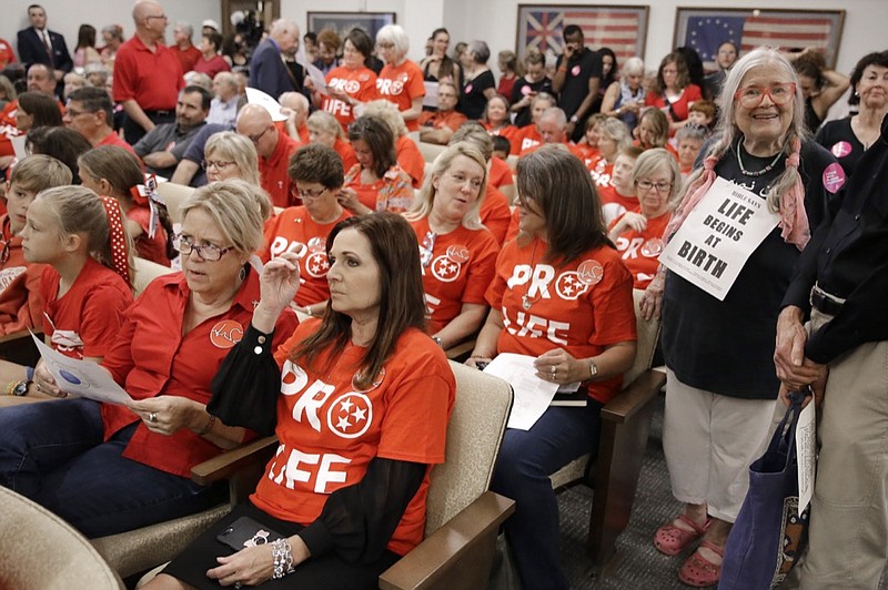 People wait for a Senate hearing to begin to discuss a fetal heartbeat abortion ban, or possibly something more restrictive, Monday, Aug. 12, 2019, in Nashville, Tenn. (AP Photo/Mark Humphrey)



