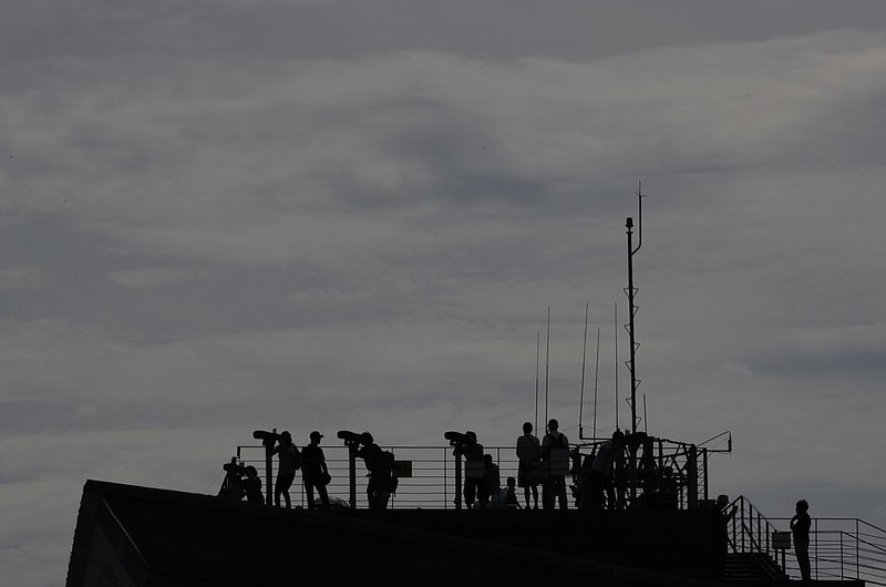 In this Sunday, Aug. 11, 2019, file photo, visitors watch the North side from the Imjingak Pavilion in Paju, South Korea. U.N. experts say they are investigating at least 35 instances in 17 countries of North Koreans using cyberattacks to illegally raise money for its nuclear program, and they are calling for sanctions against ships providing gasoline and diesel to the country. (AP Photo/Lee Jin-man, File)