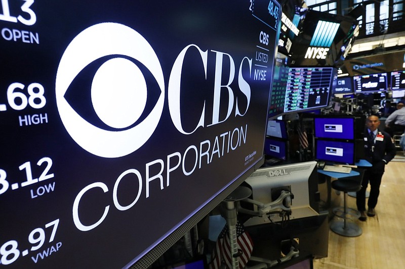 The logo for the CBS Corporation appears above a trading post on the floor of the New York Stock Exchange, Tuesday, Aug. 13, 2019. CBS and Viacom said Tuesday they will reunite, bringing together their networks and the Paramount movie studio as traditional media giants bulk up to challenge streaming companies like Netflix. (AP Photo/Richard Drew)