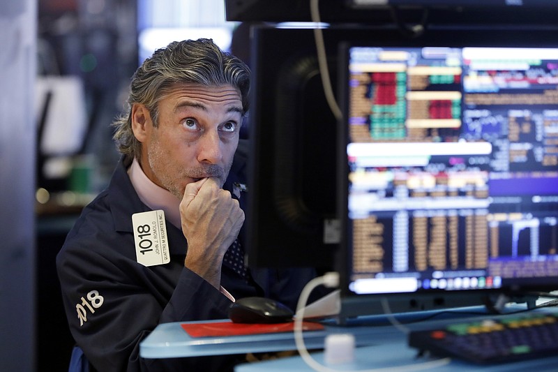 Trader John Romolo works on the floor of the New York Stock Exchange, Wednesday, Aug. 14, 2019. Stocks are falling sharply after the bond market threw up another warning flag on the economy. (AP Photo/Richard Drew)