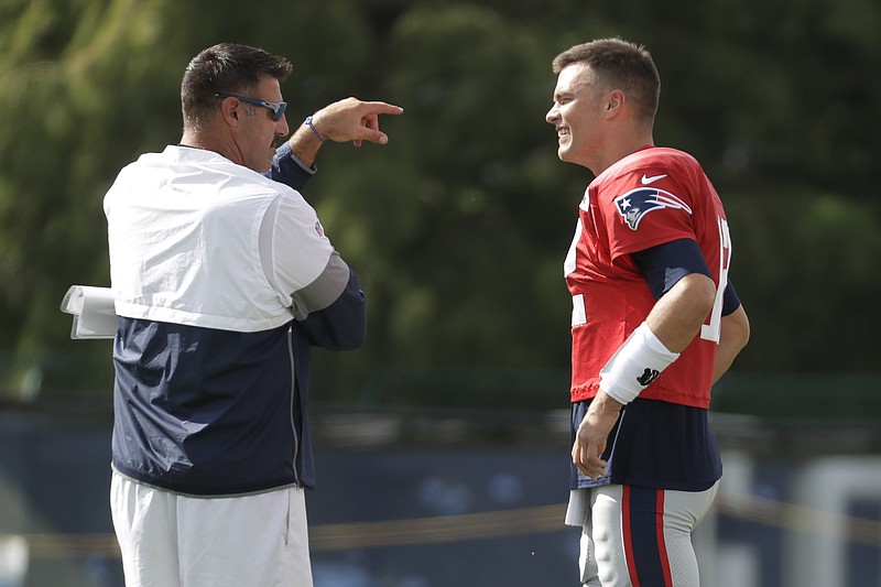 Tennessee Titans coach Mike Vrabel, left, talks with New England Patriots quarterback Tom Brady during the teams' combined practice Wednesday in Nashville. Vrabel, who won three Super Bowl rings with the Patriots, and Brady were teammates for nine seasons.