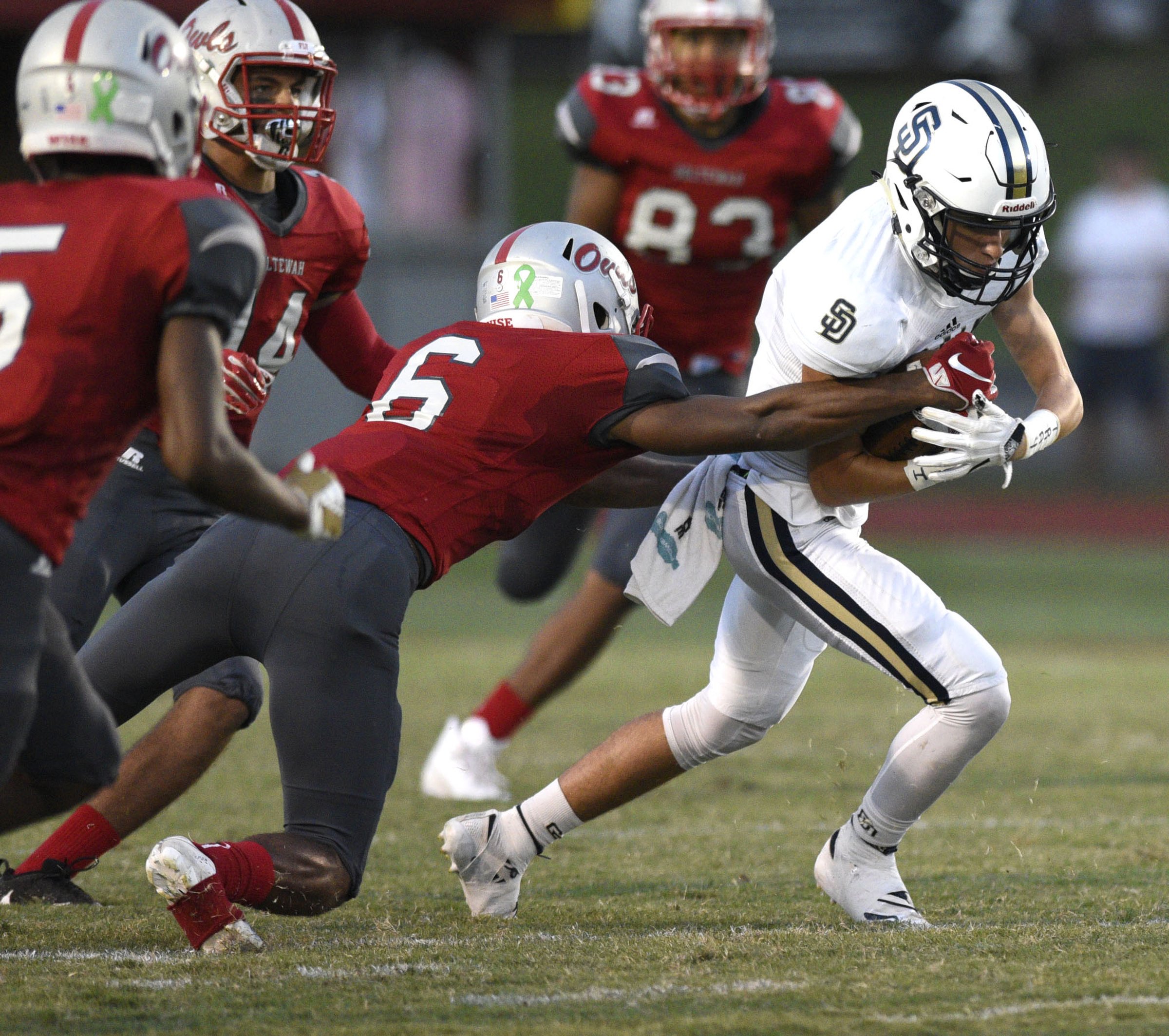 Soddy-Daisy's Isaac Barnes (2) is tackled by Ooltewah's T.J. Taylor (6). The Soddy-Daisy Trojans visited the Ooltewah Owls in a TSSAA rivalry game on September 21, 2018.