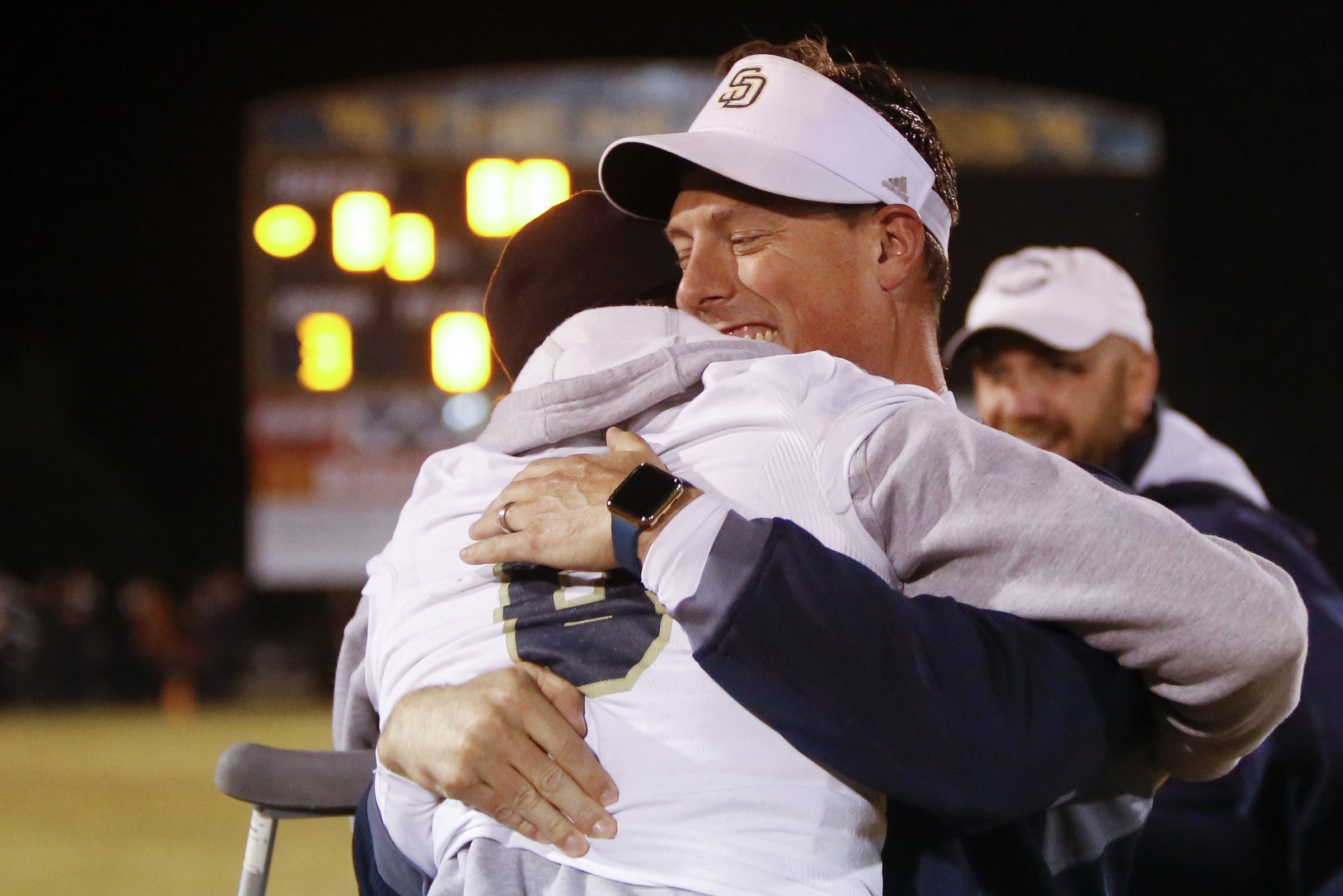 Soddy-Daisy coach Justin Barnes hugs Gavin Chambers (8) following their victory over Walker Valley at Walker Valley High School on Friday, Oct. 26, 2018 in Cleveland, Tenn.