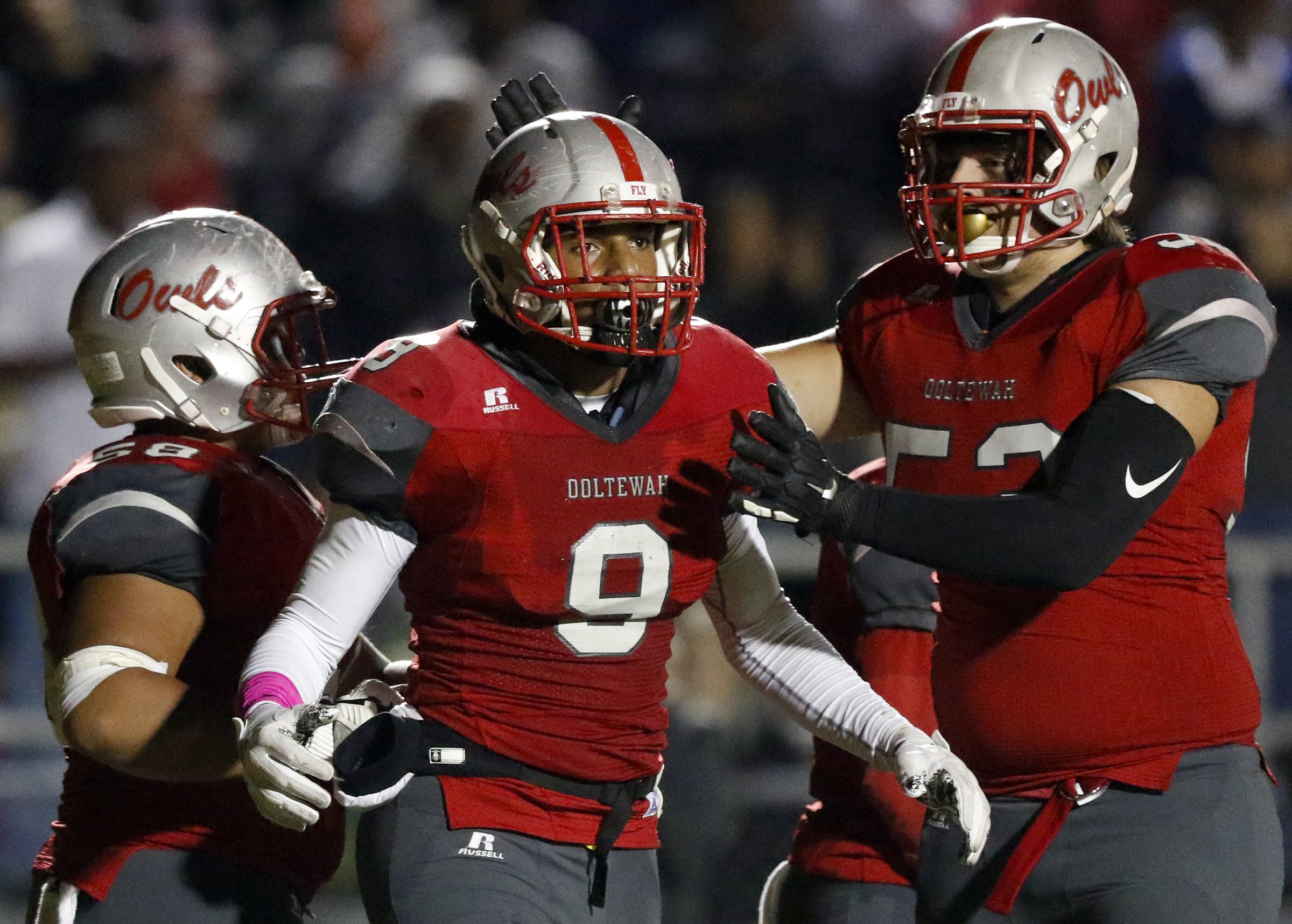 Ooltewah's Tanner Rhodes (52) congratulates teammate Malachi Quinn (9) on his touchdown against Cleveland at Ooltewah High School's James N. Monroe Stadium on Friday, Oct. 19, 2018 in Ooltewah, Tenn.