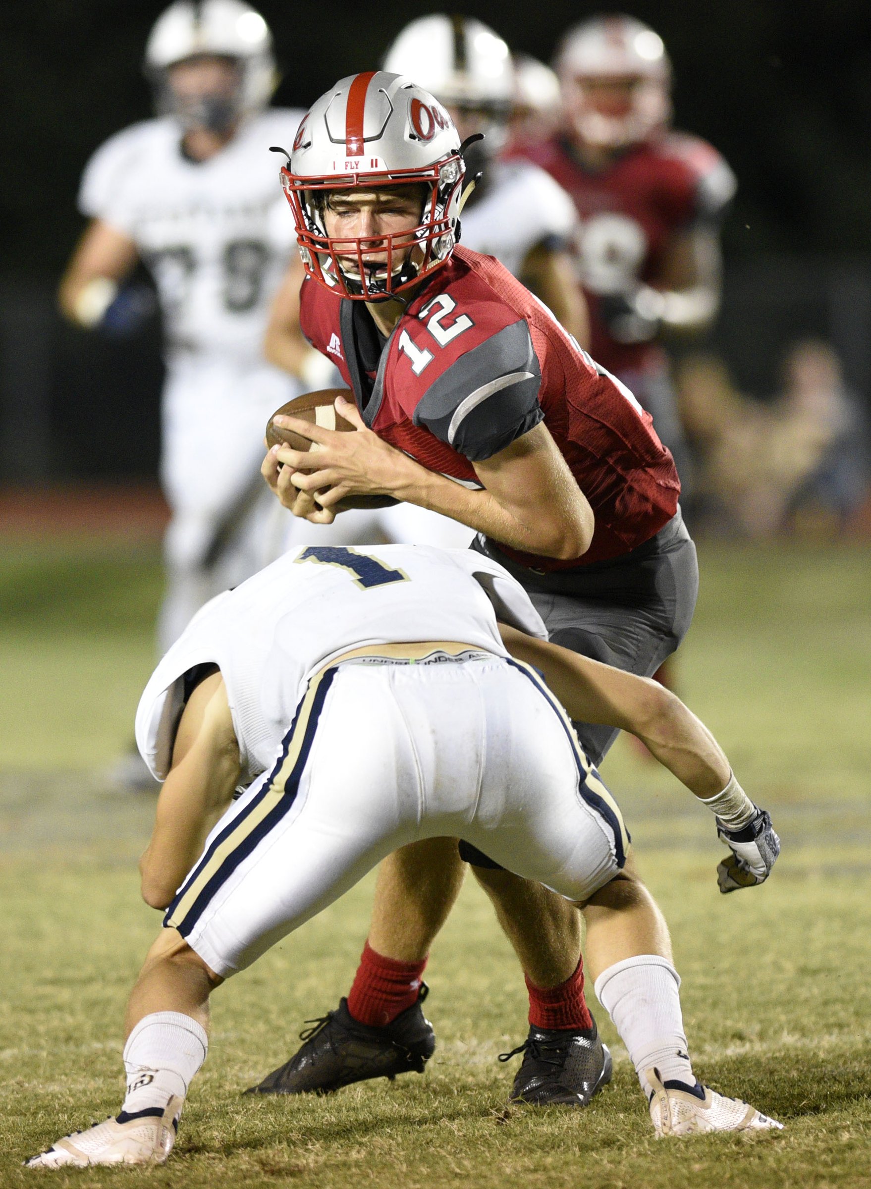 Ooltewah's Fisher Perry (12) makes a big reception to help sustain the Owl's winning drive. Spencer Gore (1) makes the stop for the Trojans. The Soddy-Daisy Trojans visited the Ooltewah Owls in a TSSAA rivalry game on September 21, 2018.