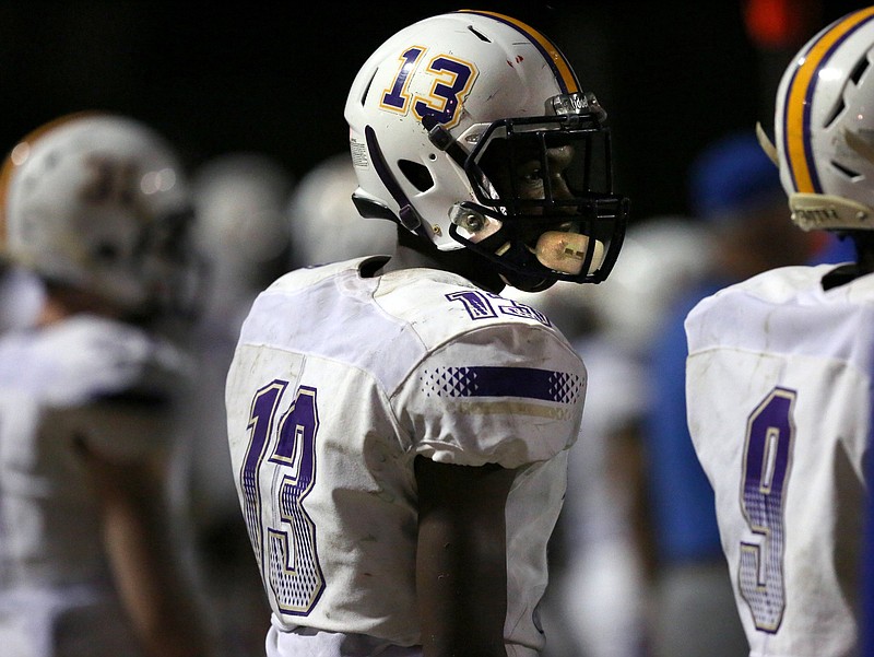 Chattanooga Central's Marquis Ray (13) watches his teammates on the field from the sideline as they move the ball downfield during the second half of the Red Bank vs. Central football game Friday, August 24, 2018 at Tom Weathers Field at Red Bank High School in Red Bank, Tennessee. Red Bank edged out Central 23-20 in overtime on a field goal. 