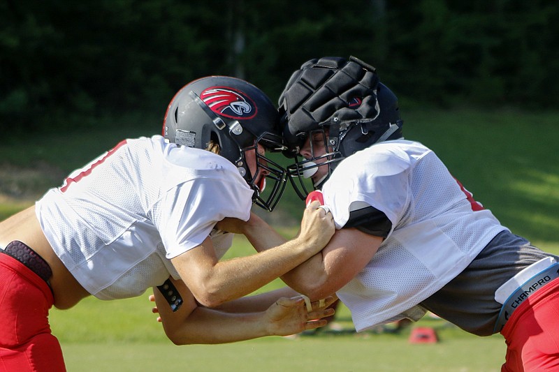 Signal Mountain's Campbell Garner, left, and Will Carter battle each other during a drill at Signal Mountain Middle/High School on Monday, July 29, 2019 in Signal Mountain, Tenn.