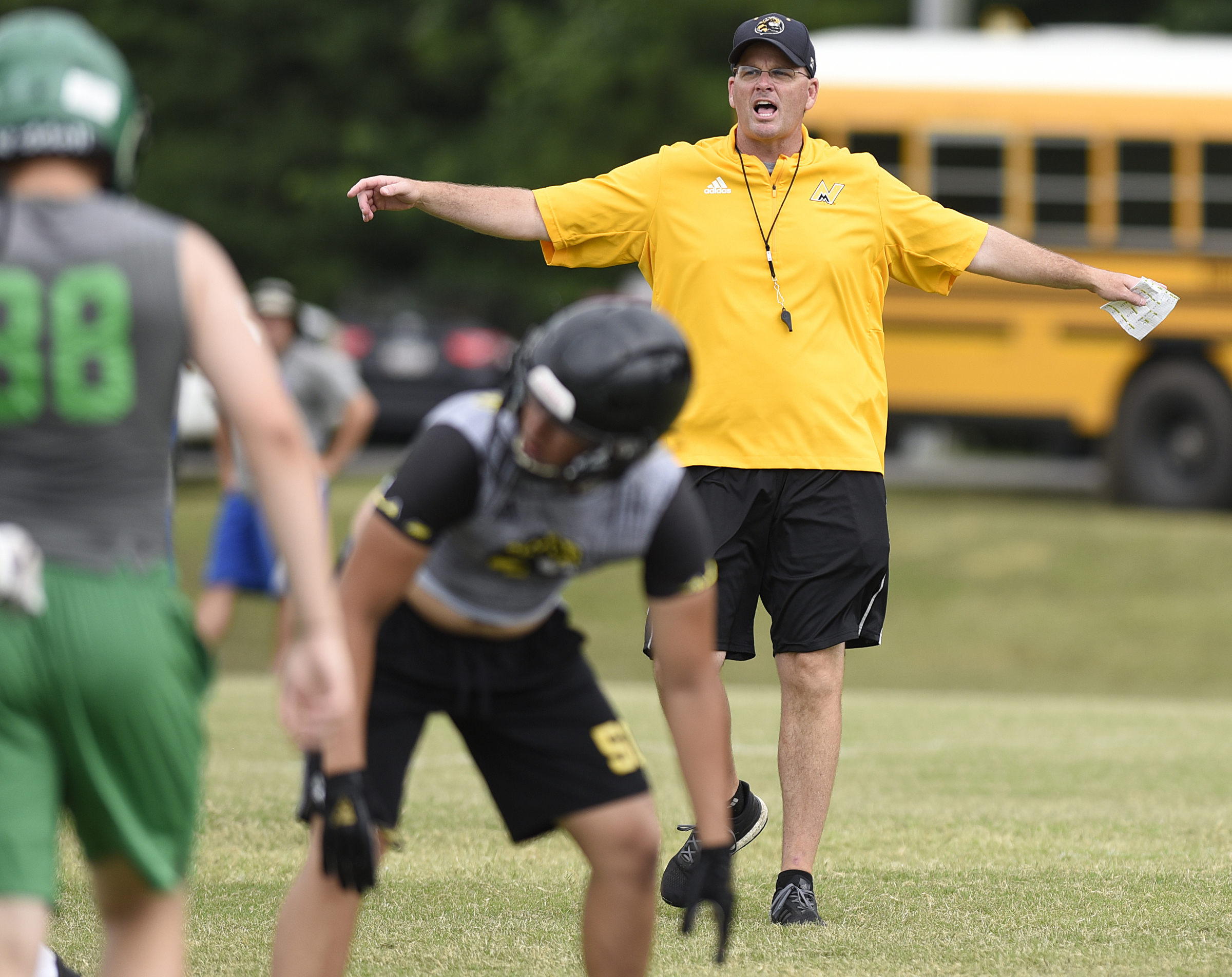 North Murray head coach Preston Poag yells to his team during a 7-on-7 scrimmage Thursday, June 21, 2018 at Southeast Whitfield High School in Dalton, Georgia.