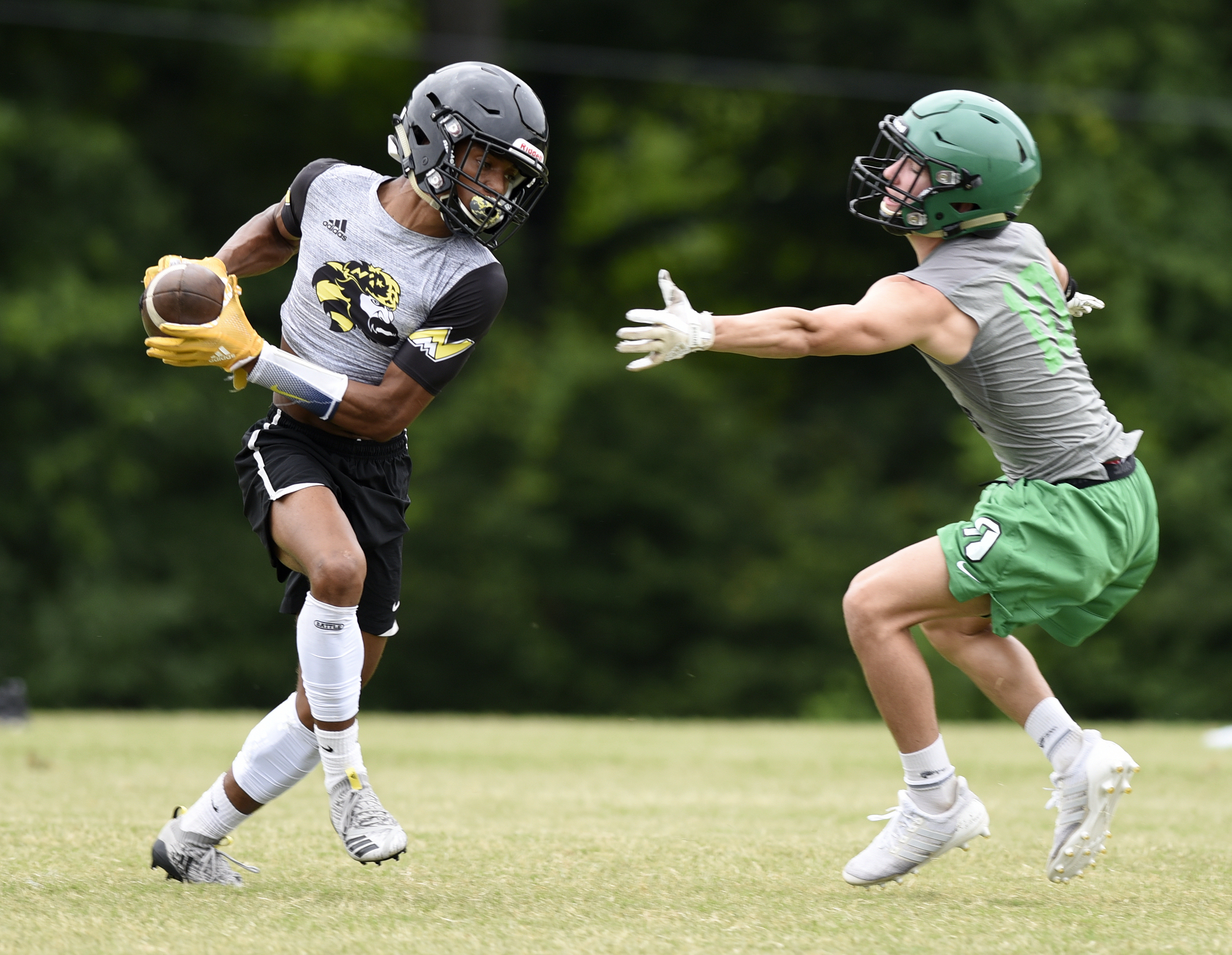 North Murray running back Dante Tidwell turns to run with a caught pass as Murray County's Ethan Chastain chases after him during a 7-on-7 scrimmage Thursday, June 21, 2018 at Southeast Whitfield High School in Dalton, Georgia.