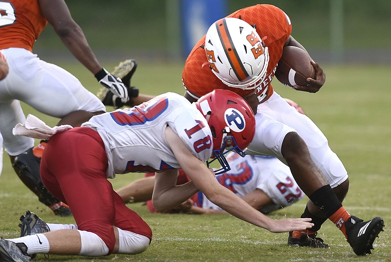 East Ridge's Alonzo Russell (4) lowers his head as he tackledy by Polk's Kole Green (18).  The East Ridge Pioneers hosted the Polk County Wildcats in TSSAA football action on August 14, 2018.  